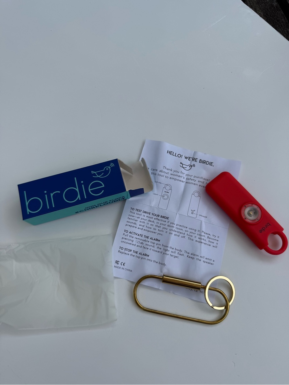 Birdie Personal Safety Alarm Keychain in Bright Red with Gold Ring